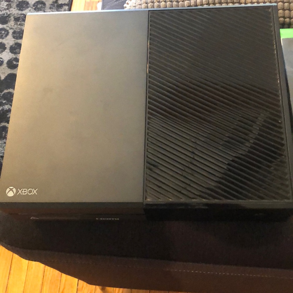 Xbox One Console and Five Video Games and Two Controllers.